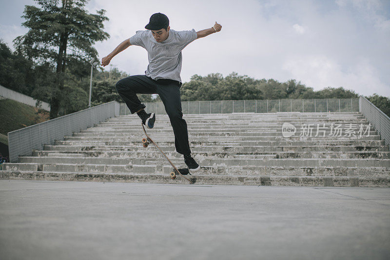 Asian skateboarder in action mid air x games